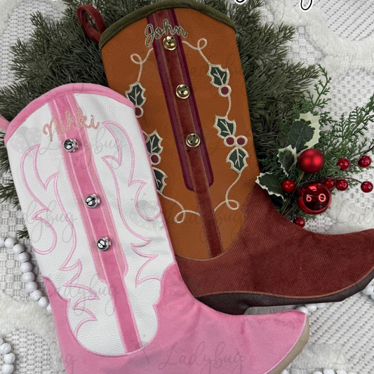 Two embroidered Christmas stockings, one brown and one pink, with decorative elements on a textured background.